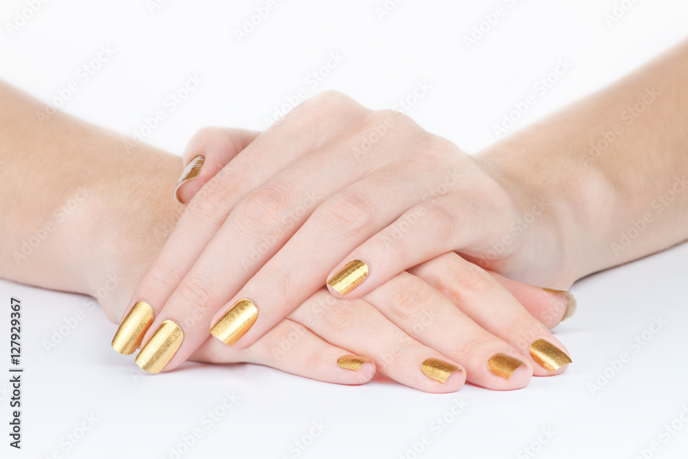 Fototapeta premium Golden manicure fingers closeup