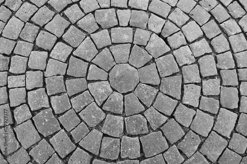 Round stone pavement pattern. Top view of black stone pavement texture