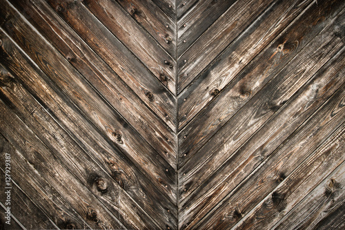 Diagonal background of dark brown wooden texture