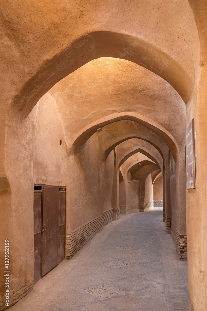 Old passage with traditional clay arches in the city of Yazd, Ir