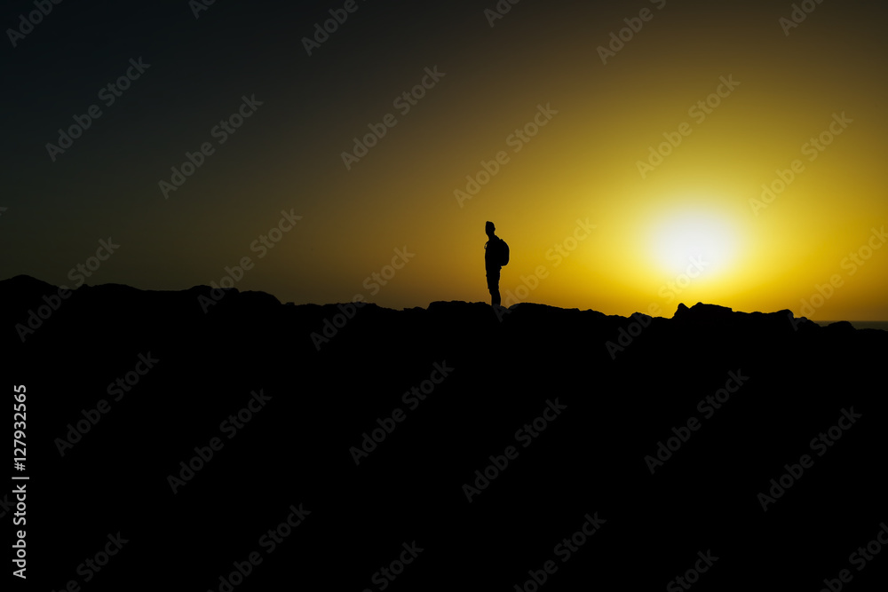 silhouette of young man at dusk