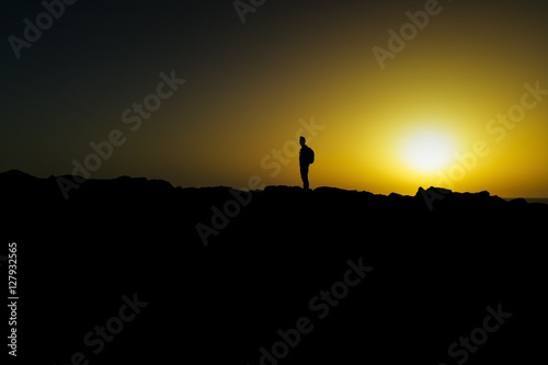 silhouette of young man at dusk