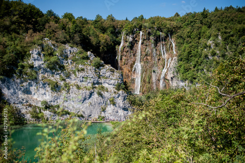 Waterfall and turquoise pond in the forest. Plitvice Lakes in National Park in Croatia.