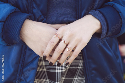 Female hands with collection of hipster golden rings