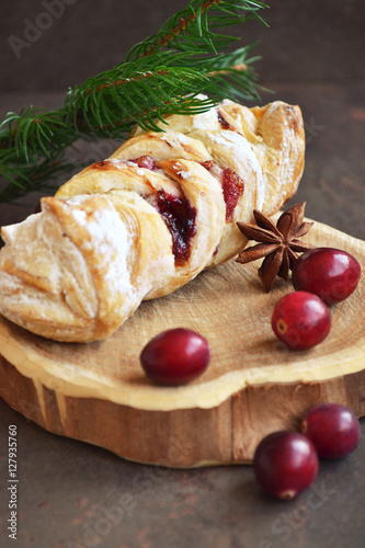 Buttery croissants with fruit jam, served on the wooden tray, decorated fresh cranberries, powder coating. Winter Holidays Concept