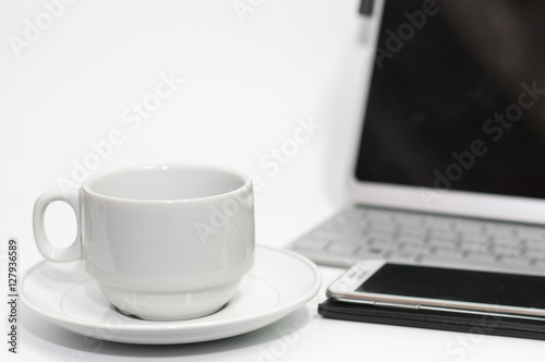 Coffee cup on white desk and laptop for background,drink between