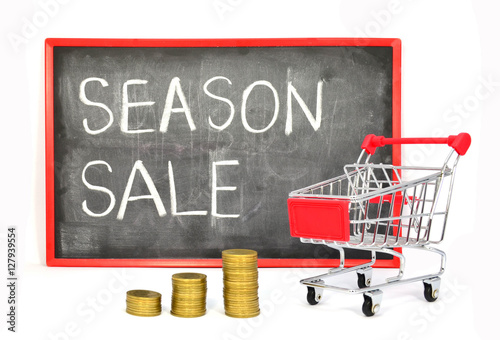 Shopping cart with chalk written word "Season Sale" on black boa