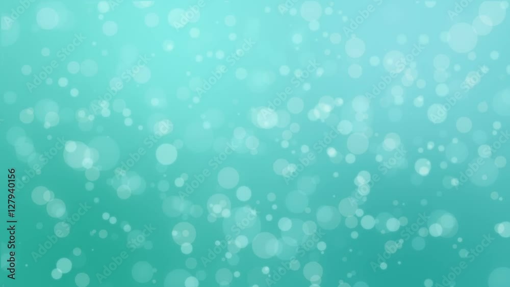 Bokeh holiday background with flickering bubbles against a gradient teal blue green backdrop