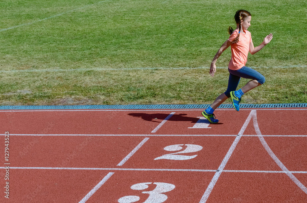 Kids sport, child running on stadium track, training and fitness concept
