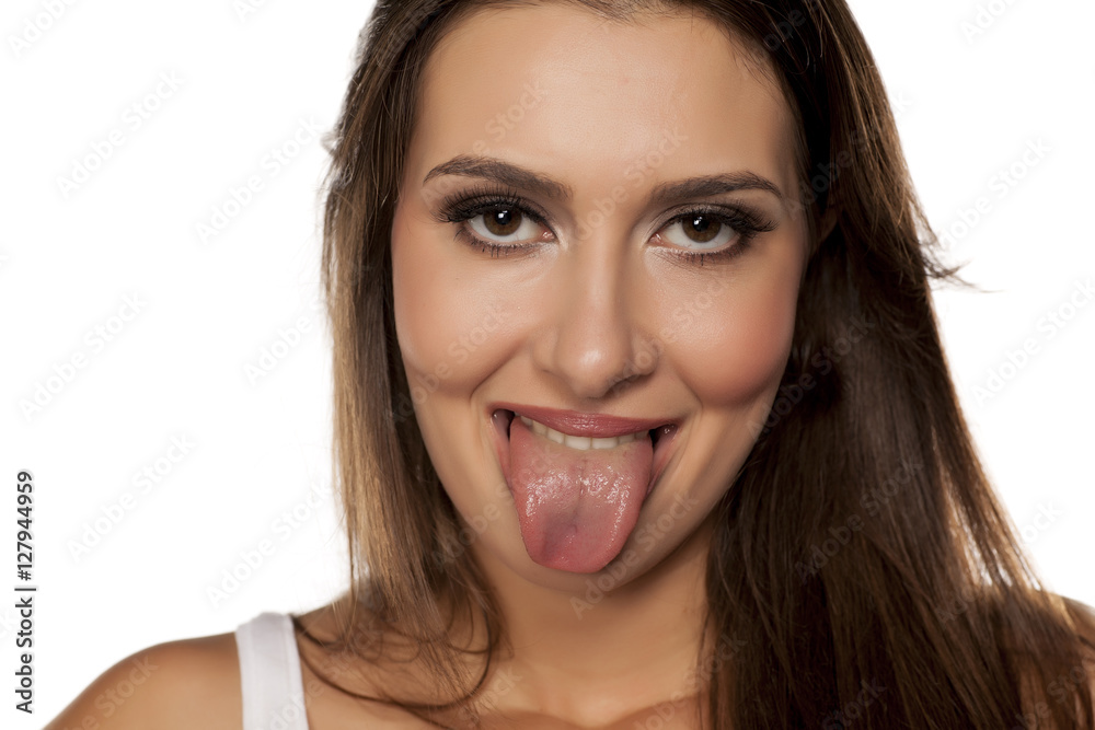 smiling young woman shows her tongue smiling young woman shows her tongue