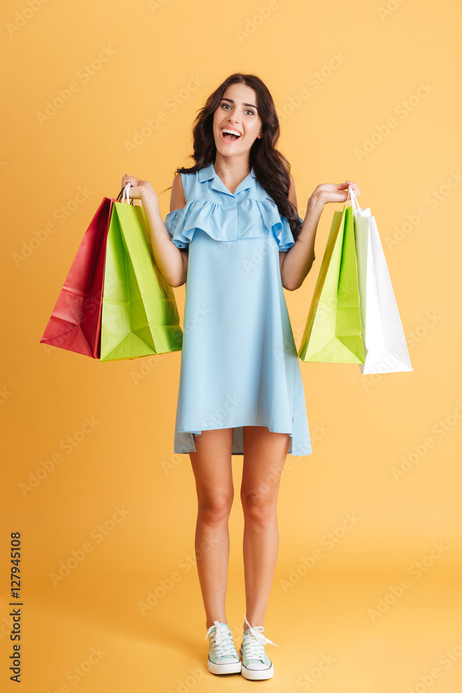 Smiling casual girl holding shopping bags