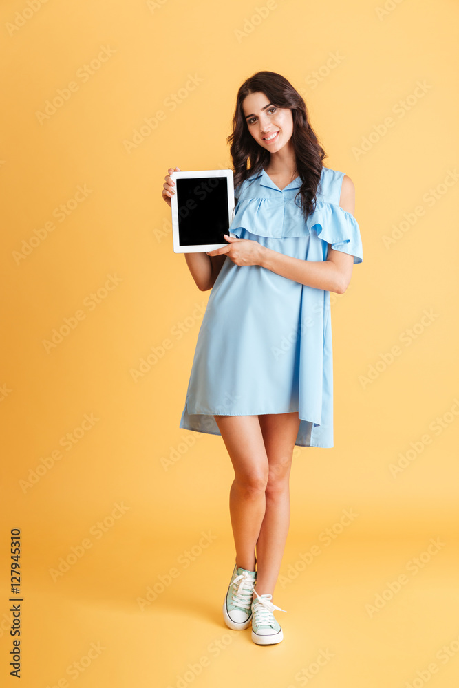 Smiling casual woman showing blank tablet computer screen Smiling casual woman showing blank tablet computer screen