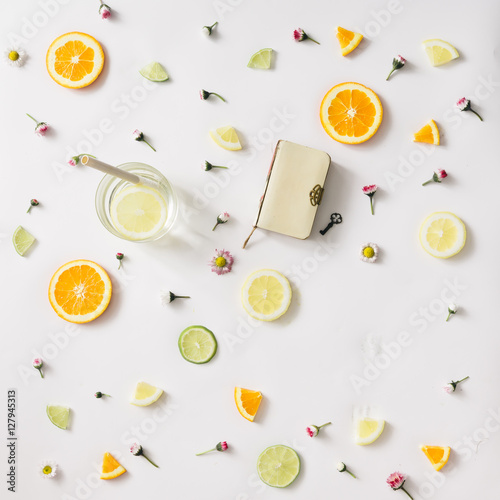 Colorful pattern made of citrus fruits and flowers. Flat lay