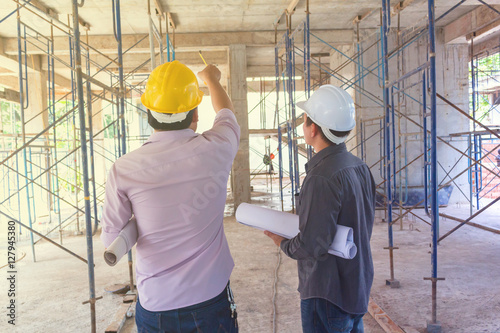 engineer checks the drawing building construction at a construction site