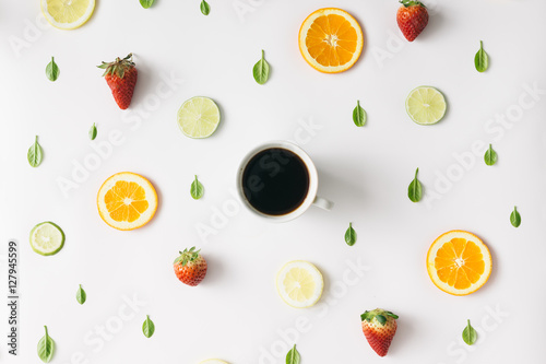 Colorful  coffee pattern made of citrus fruits and strawberries.