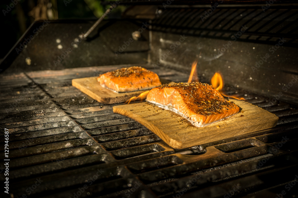 Salmon on cedar wood plank cooking on a BBQ grill Stock Photo | Adobe Stock