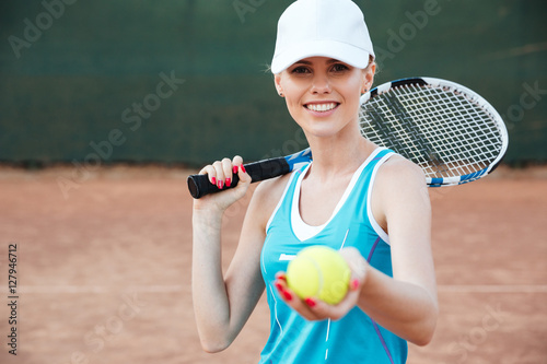 Tennis woman giving ball © Drobot Dean