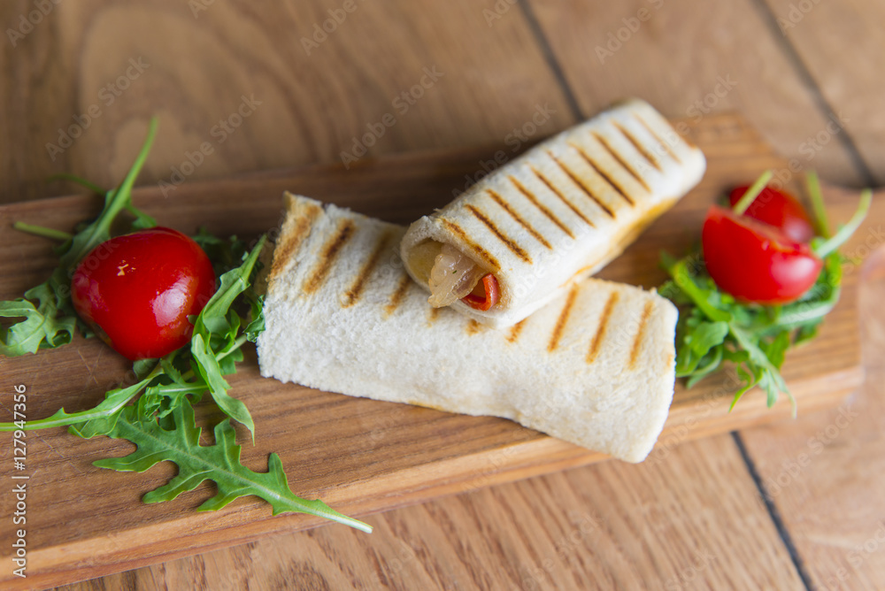 Wrap sandwich with salami and bacon , lettuce, tomatoes, ruccola, green olives Wrap sandwich with salami and bacon , lettuce, tomatoes, ruccola, green olives