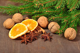 Different kinds of spices, nuts, dried oranges and spruse branch