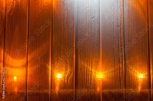 Luminous Christmas garland on a wooden background.
