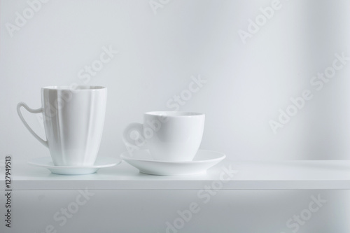 Clean cups on wooden shelf