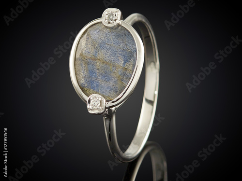 silver ring with gemstone isolated on black background