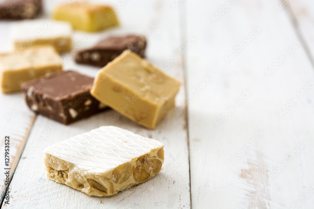 Variety of Christmas nougat on white wooden background
