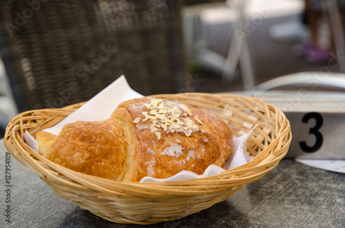 Single croissant in a basket photo