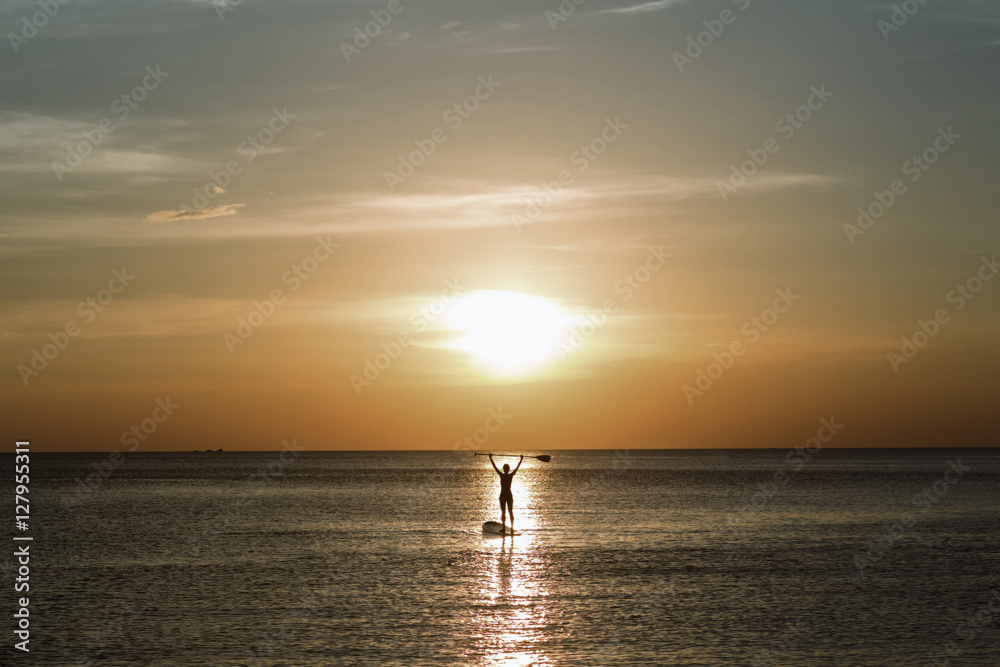 Handsome man surfing board in the tranquil sea (silhouette). Handsome man surfing board in the tranquil sea (silhouette).