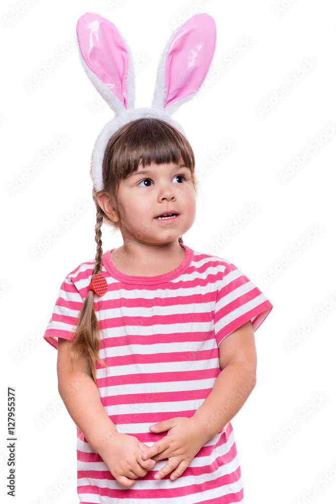Happy little girl with pink rabbit ears. Portrait of cute caucasian baby wearing bunny ears. Funny preschool child, isolated on white background. Healthy carefree kid - Easter holidays concepts. Happy little girl with pink rabbit ears. Portrait of cute caucasian baby wearing bunny ears. Funny preschool child, isolated on white background. Healthy carefree kid - Easter holidays concepts.