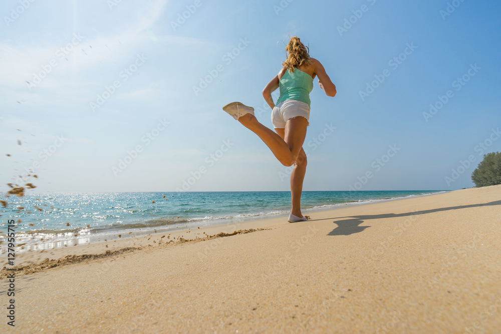 Woman high speed running on the beautiful beach. Selective focus, runner in motion blur. Woman high speed running on the beautiful beach. Selective focus, runner in motion blur.