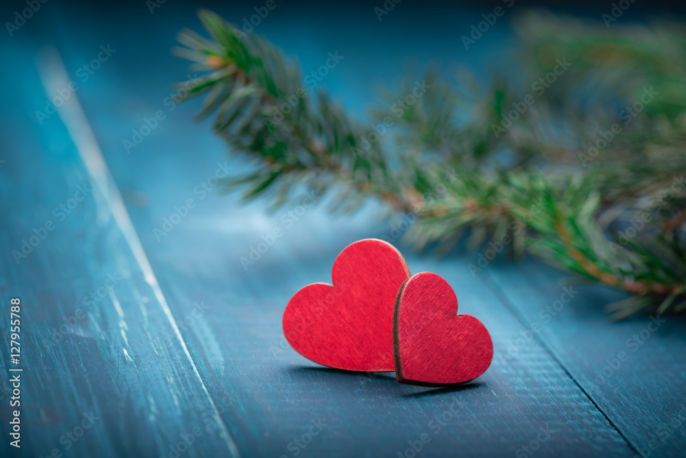 Two red wooden hearts on blue table. Christmas decoration. Copy space. Valentine. Love.