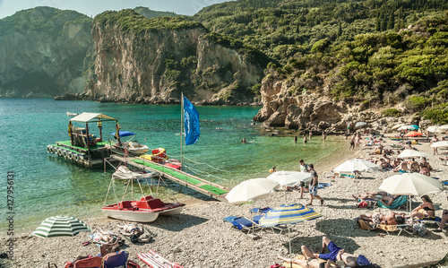 CORFU ISLAND, GREECE - August 10, 2014: Beautiful beach of Paleokastritsa. Tourists enjoying a nice summer day at the beach. Kerkyra island