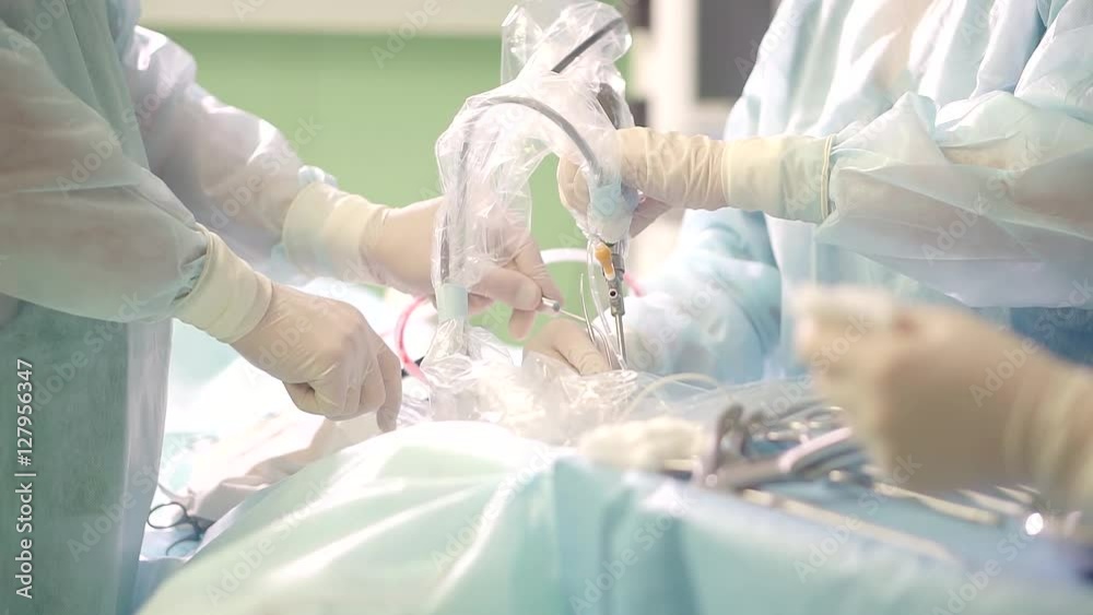 Doctor performs endoscopic surgery removing a brain tumor. Doctor performs endoscopic surgery removing a brain tumor.