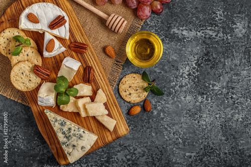 Assortment of cheese with honey, nuts and grape 
