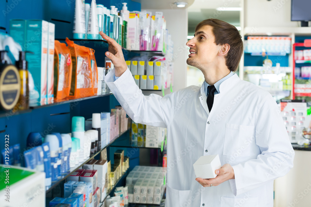 Male pharmacist  in drugstore.