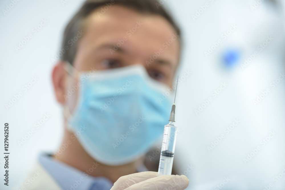 doctor in medical mask ready to make injection doctor in medical mask ready to make injection