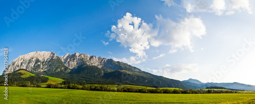 beautiful mountains landscape with water sea and green gras daylight daytime © Sebastian