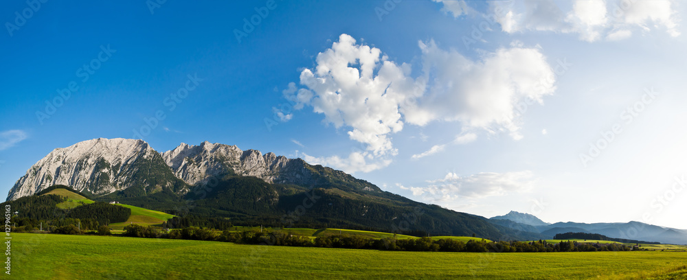 beautiful mountains landscape with water sea and green gras daylight daytime
