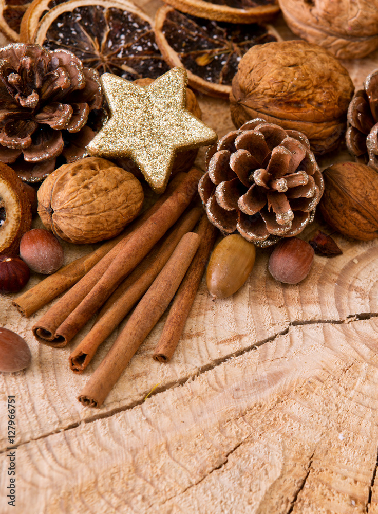 Christmas decoration with different nuts and cinnamon sticks.