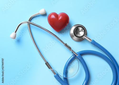 Stethoscope and red heart on table