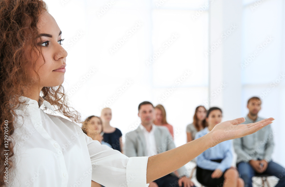Business trainer giving presentation to group of people Business trainer giving presentation to group of people