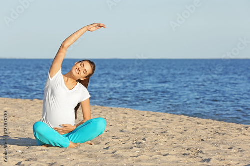 Young pregnant woman doing ...