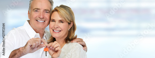 Senior couple with house key.