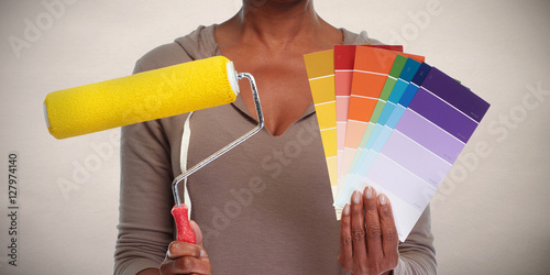Woman hands with painting roller.