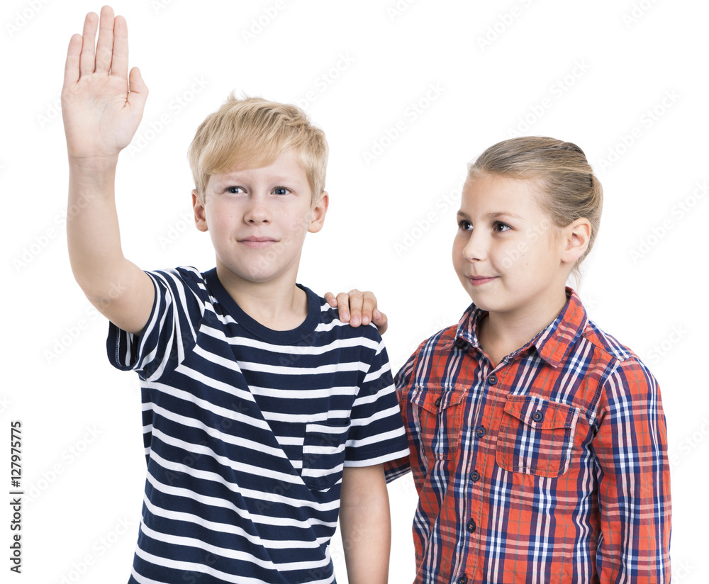 Eight years Caucasian boy and girl pushing a button, isolated on white background Eight years Caucasian boy and girl pushing a button, isolated on white background