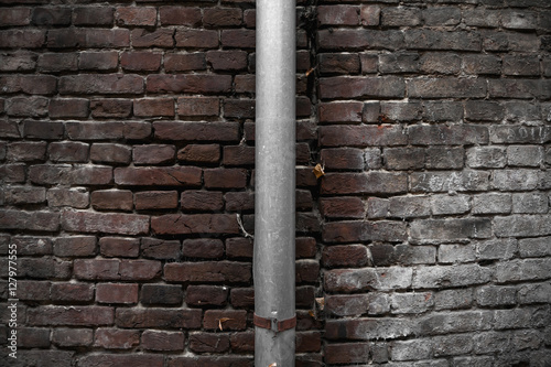 Texture old brick wall and metal pipe