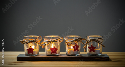 Four Advent candles on grey