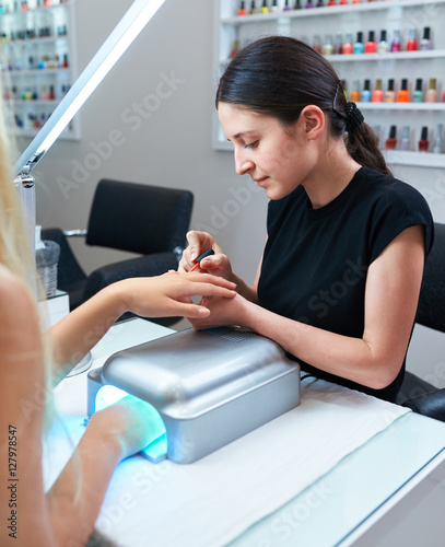 shellac coating procedure. manicure nail paint , hand rests in the