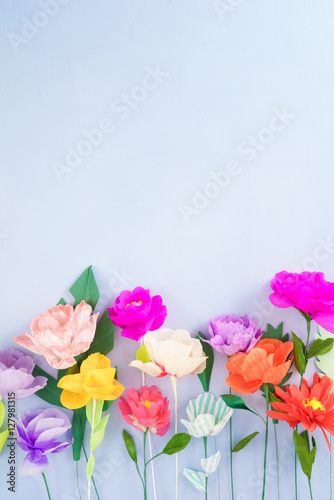 Fototapeta Naklejka Na Ścianę i Meble -  Colourful handmade paper flowers on light blue background with copyspace